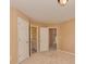 Carpeted bedroom with an ensuite bathroom and multiple closets and doors at 5607 Fulton Ridge Dr, Indian Trail, NC 28079