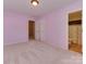Spacious bedroom with plush carpeting, double closets, and en-suite bathroom access at 5607 Fulton Ridge Dr, Indian Trail, NC 28079