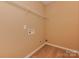 Empty closet with a single wire shelf, light beige walls, and vinyl flooring at 5607 Fulton Ridge Dr, Indian Trail, NC 28079