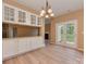 Dining area with white built-in cabinets, chandelier, and a door to the outdoor area at 5607 Fulton Ridge Dr, Indian Trail, NC 28079
