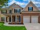 Charming two-story home featuring a two-car garage, brick accents, and a welcoming front porch at 5607 Fulton Ridge Dr, Indian Trail, NC 28079