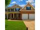 Charming two-story home with a well-manicured lawn and a two-car garage at 5607 Fulton Ridge Dr, Indian Trail, NC 28079