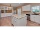 Open kitchen area featuring an island, built-in cabinets, and stainless steel appliances and sink at 5607 Fulton Ridge Dr, Indian Trail, NC 28079