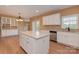 Bright kitchen with island, stainless dishwasher, white cabinets, and modern fixtures at 5607 Fulton Ridge Dr, Indian Trail, NC 28079