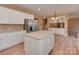 Bright kitchen features white cabinets, a stainless steel refrigerator, and a center island with a light countertop at 5607 Fulton Ridge Dr, Indian Trail, NC 28079