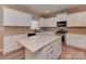 Updated kitchen with white cabinets, stainless steel appliances, and a center island with a neutral countertop at 5607 Fulton Ridge Dr, Indian Trail, NC 28079
