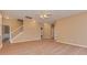 Open living space with neutral walls, light vinyl flooring, a staircase, and a ceiling fan at 5607 Fulton Ridge Dr, Indian Trail, NC 28079