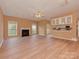 Spacious living area with light vinyl flooring, fireplace, and a view into kitchen and dining area at 5607 Fulton Ridge Dr, Indian Trail, NC 28079