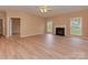 Bright living room boasts light vinyl flooring, neutral walls, a fireplace, and large windows at 5607 Fulton Ridge Dr, Indian Trail, NC 28079