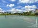 Well-maintained community tennis court for recreational play surrounded by lush greenery and landscaping at 5607 Fulton Ridge Dr, Indian Trail, NC 28079