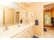 Bathroom with double vanity, large mirror, and a view from a window at 6119 Bittersweet Ln, Charlotte, NC 28270