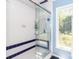Bright bathroom featuring a shower with glass door and a window providing natural light at 6119 Bittersweet Ln, Charlotte, NC 28270