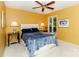 Inviting bedroom with sunny yellow walls, cozy bedding, and abundant natural light at 6119 Bittersweet Ln, Charlotte, NC 28270