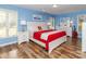 A bright bedroom featuring hardwood floors and large windows for plenty of natural light at 6119 Bittersweet Ln, Charlotte, NC 28270