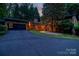 Home exterior with a garage, modern yard art, and a spacious driveway at 6119 Bittersweet Ln, Charlotte, NC 28270