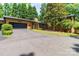 Wide exterior view of a well-maintained home with an extended driveway and lush greenery, with a 2 car garage at 6119 Bittersweet Ln, Charlotte, NC 28270