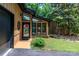 Inviting entrance with large windows, black trim, and colorful welcome decor, showcasing a blend of modern and classic design at 6119 Bittersweet Ln, Charlotte, NC 28270