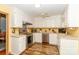 A kitchen featuring white cabinets, stainless steel appliances, and beautiful wood flooring at 6119 Bittersweet Ln, Charlotte, NC 28270