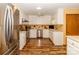 A kitchen featuring white cabinets, stainless steel appliances, and beautiful wood flooring at 6119 Bittersweet Ln, Charlotte, NC 28270