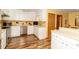 Classic kitchen with white cabinets, updated appliances, and wood flooring, offering a clean and functional space at 6119 Bittersweet Ln, Charlotte, NC 28270