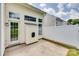 View of the backyard showcasing a back door entrance and an adjacent white fence for enhanced privacy at 622 Bayou Cir, Clover, SC 29710