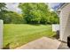 View of a well-maintained backyard with lush lawn, mature trees, and a privacy fence at 622 Bayou Cir, Clover, SC 29710