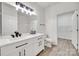 Modern bathroom has dual sink vanity, a large mirror and access to a walk-in closet at 622 Bayou Cir, Clover, SC 29710