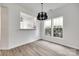 Bright eat-in kitchen boasts natural light, modern chandelier, and a view into the spacious kitchen at 622 Bayou Cir, Clover, SC 29710
