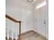 Bright foyer featuring wood-look floors and a staircase with a wooden handrail at 622 Bayou Cir, Clover, SC 29710