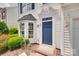 Close up view of a blue front door with elegant trim, and neat landscaping at 622 Bayou Cir, Clover, SC 29710
