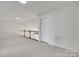 Upstairs loft area with neutral carpet and white walls overlooking the stairwell at 622 Bayou Cir, Clover, SC 29710