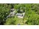 An aerial view of the home surrounded by mature trees, nearby streets, and manicured lawns at 6406 Old Meadow Rd, Charlotte, NC 28227