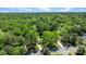 Scenic aerial shot of a residential area surrounded by vibrant green trees with houses nestled in nature at 6406 Old Meadow Rd, Charlotte, NC 28227