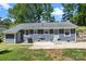 The backyard features a well-manicured lawn, concrete patio, and neutral-colored siding at 6406 Old Meadow Rd, Charlotte, NC 28227