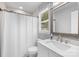 Bright bathroom with marble countertop, window, and shower with tub at 6406 Old Meadow Rd, Charlotte, NC 28227