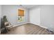 Bedroom with hardwood floors, closet, and natural light at 6406 Old Meadow Rd, Charlotte, NC 28227