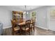 Classic dining room with wooden table, chairs, and display cabinet under a chandelier at 6406 Old Meadow Rd, Charlotte, NC 28227
