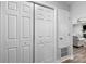 Hallway with large closets, white doors and walls, and view into the living room at 6406 Old Meadow Rd, Charlotte, NC 28227