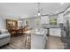 Bright, open-concept kitchen with granite island, stainless appliances, and adjacent dining area at 6406 Old Meadow Rd, Charlotte, NC 28227