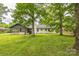 Exterior view showcasing a covered porch and well-maintained lawn, ideal for relaxation at 6641 Pawnee Dr, Charlotte, NC 28214