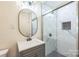 Bathroom featuring a sink with gray vanity, a glass enclosed shower, and modern finishes at 6641 Pawnee Dr, Charlotte, NC 28214