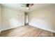 Bedroom with wood flooring, neutral walls, ceiling fan, and a closet with bi-fold doors at 6641 Pawnee Dr, Charlotte, NC 28214