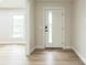 Bright entryway with modern door, light wood floors and fresh, neutral paint at 6641 Pawnee Dr, Charlotte, NC 28214