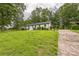 A wide view showing a well-maintained lawn and the side of the home at 6641 Pawnee Dr, Charlotte, NC 28214