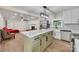 Bright, modern kitchen with stainless appliances, large island with marble countertop, and an open view to the living area at 6641 Pawnee Dr, Charlotte, NC 28214