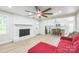 Living room with brick fireplace and kitchen view at 6641 Pawnee Dr, Charlotte, NC 28214