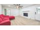 Bright living room boasts fireplace, wood floors and open floorplan at 6641 Pawnee Dr, Charlotte, NC 28214
