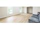 Bright living room with wood floors, large windows, and neutral paint at 6641 Pawnee Dr, Charlotte, NC 28214