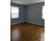 Sunny bedroom features hardwood floors, natural light, and neutral wall color at 715 Gentry Pl, Charlotte, NC 28210