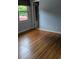 Cozy bedroom with gleaming hardwood floors, and a window at 715 Gentry Pl, Charlotte, NC 28210